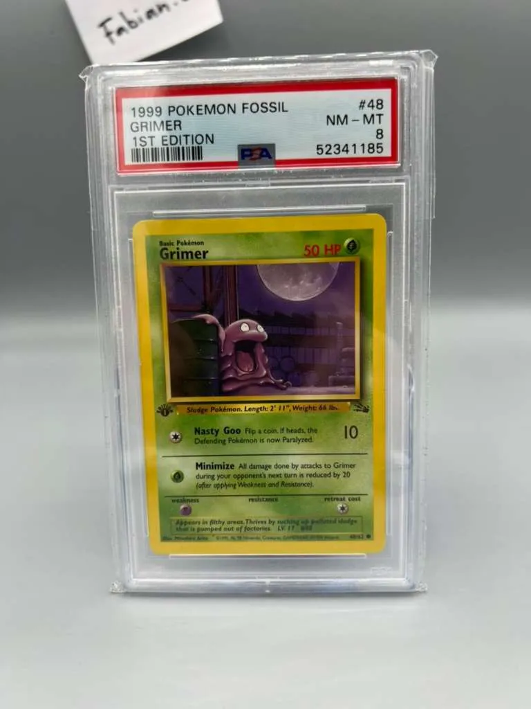 first edition grimer pokemon card 2000 Pokmon Team Rocket 1st 57/82 CGC 9 Mint Oblivion Collectibles flip a coin Pokemon Grimer First Edition PSA