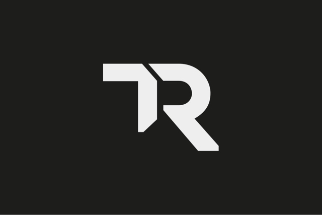 T.